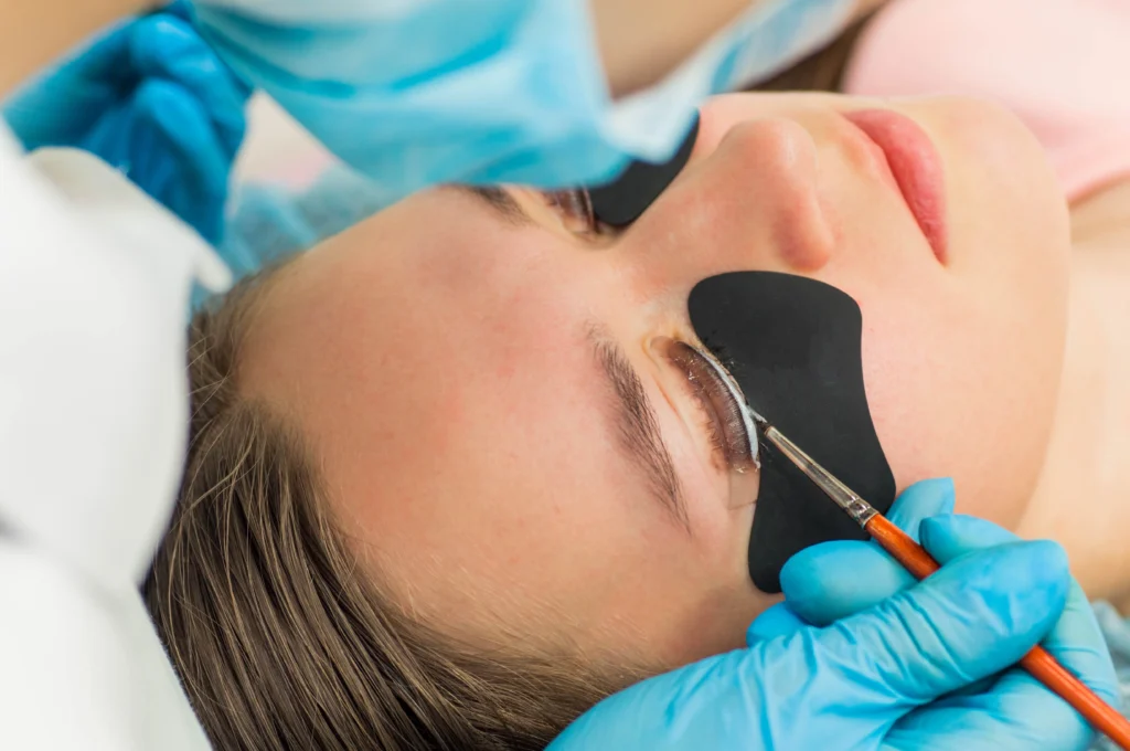 The image shows a client receiving a lash lift treatment.