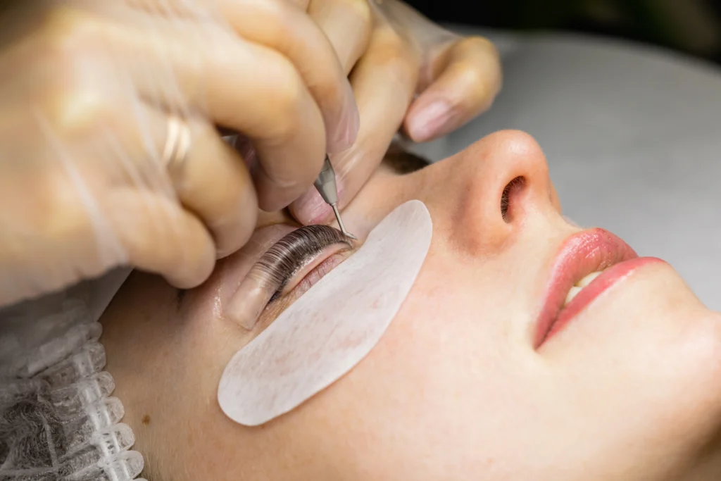 The image shows a close-up of a client undergoing a lash lift treatment.