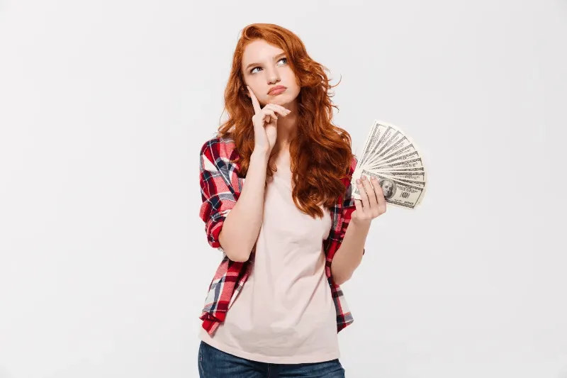 The image shows a young woman with a decision-making about whether a purchase or investment, such as a cosmetic procedure, is worth the cost.