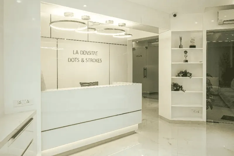 The image displays a clean and modern reception area of Dots & Strokes Clinic, emphasizing professionalism and a welcoming environment.