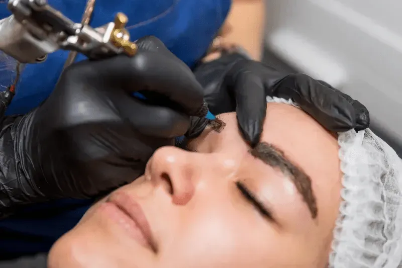 This image shows a close-up of a person undergoing a microblading procedure.